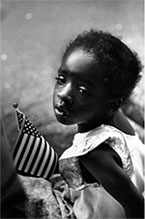 Photograph by Earlie Hudnall, girl with flag 1991, on exhibition at Petter Fetterman Gallery in Santa Monica, CA, June 11 - September 3, 2022, 052822